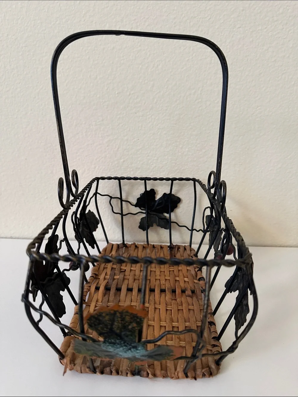 Black Metal and Brown Woven Decorative Basket with Green Leaf Accents